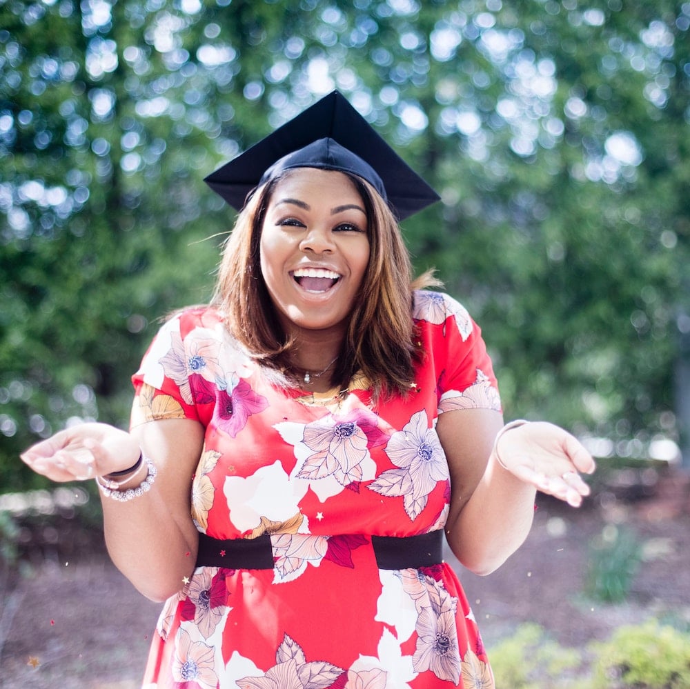 A young woman celebrating her graduation.